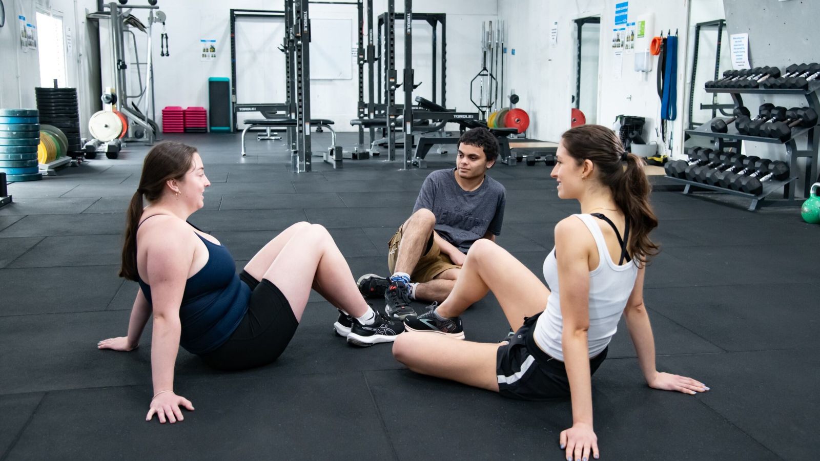 People sitting together on the floor of the Functional Training Room